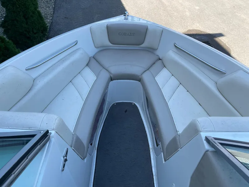 Slide: The Image of 1996 Cobalt 190 Bowrider boat interior with white seating and gray carpet. - 8