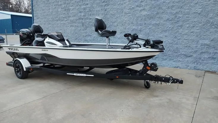 Slide: The Image of 2025 Vexus AVX1880 boat on trailer, parked on concrete near blue building. - 12