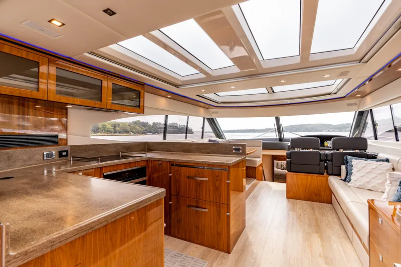 Slide: The Image of Luxurious interior of 2017 Riviera 6000 Sport Yacht with modern kitchen and panoramic windows. - 13