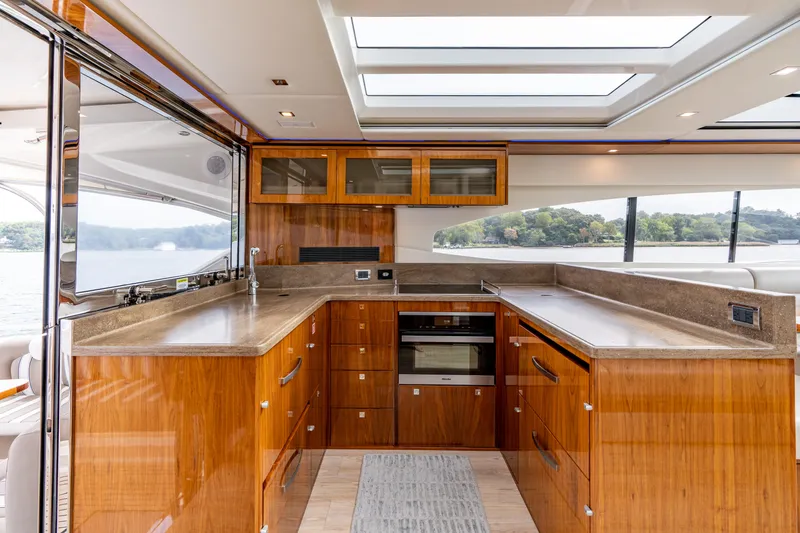 Slide: The Image of Luxurious interior of 2017 Riviera 6000 Sport Yacht with modern kitchen and scenic windows. - 14