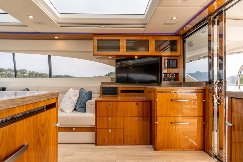 Slide: The Image of Luxurious interior of 2017 Riviera 6000 Sport Yacht with wood cabinetry and modern amenities. - 17