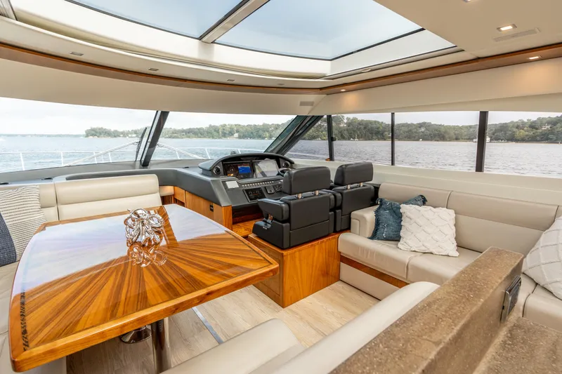 Slide: The Image of Luxurious interior of 2017 Riviera 6000 Sport Yacht with elegant seating and panoramic windows. - 18