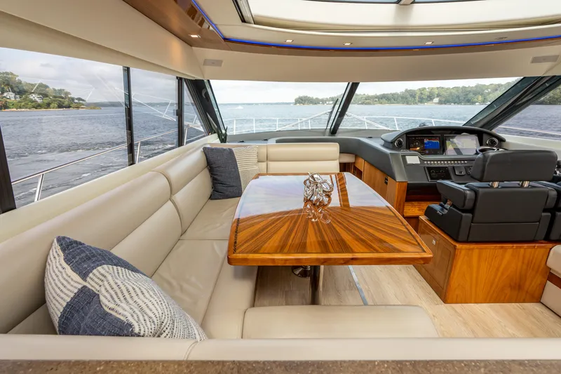 Slide: The Image of Luxurious interior of 2017 Riviera 6000 Sport Yacht with elegant seating and wooden table. - 19