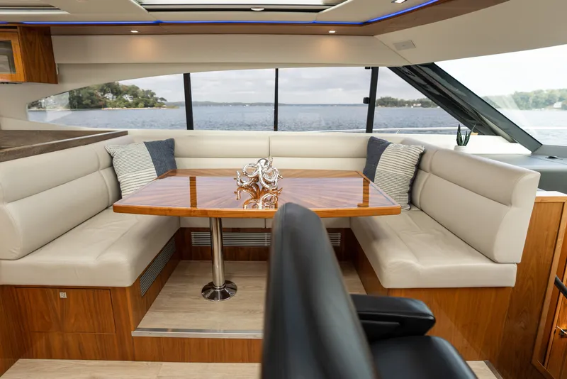 Slide: The Image of Luxurious interior of 2017 Riviera 6000 Sport Yacht with elegant seating and scenic window view. - 20