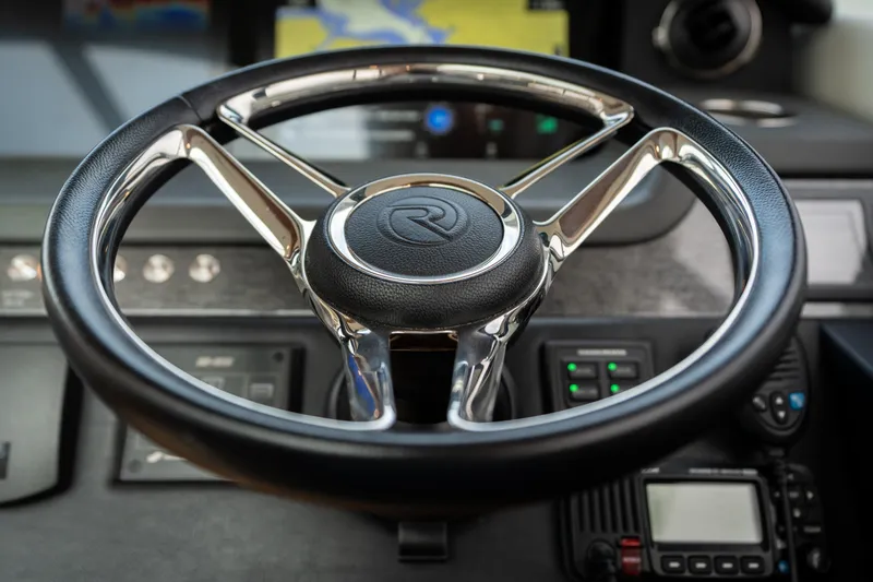 Slide: The Image of Steering wheel of 2017 Riviera 6000 Sport Yacht, featuring sleek design and modern controls. - 21