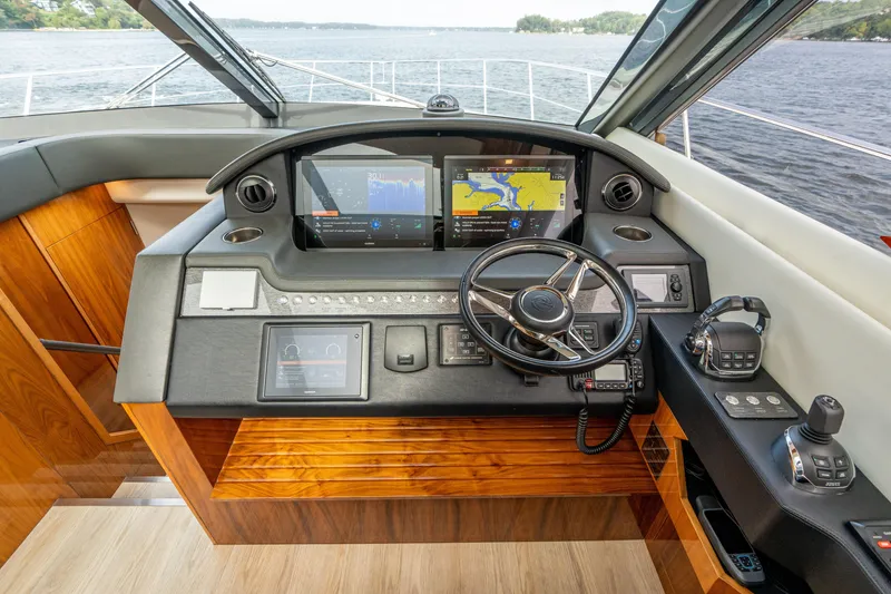 Slide: The Image of Helm of 2017 Riviera 6000 Sport Yacht with navigation screens and steering wheel. - 22
