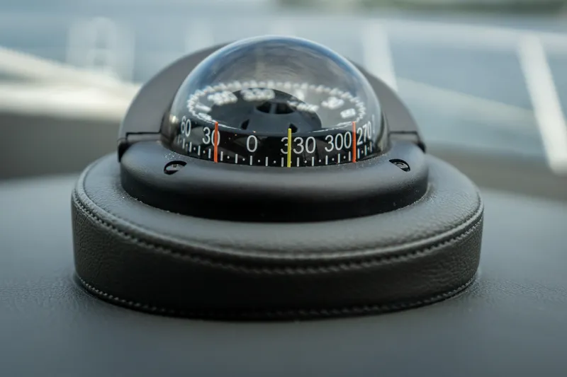 Slide: The Image of Compass on 2017 Riviera 6000 Sport Yacht dashboard, close-up view. - 24