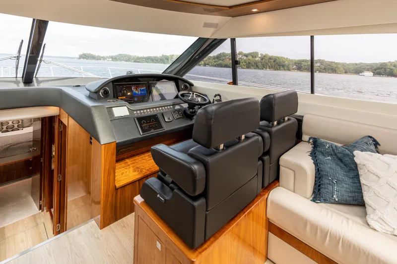 Slide: The Image of Interior of 2017 Riviera 6000 Sport Yacht with luxurious helm and seating area. - 25