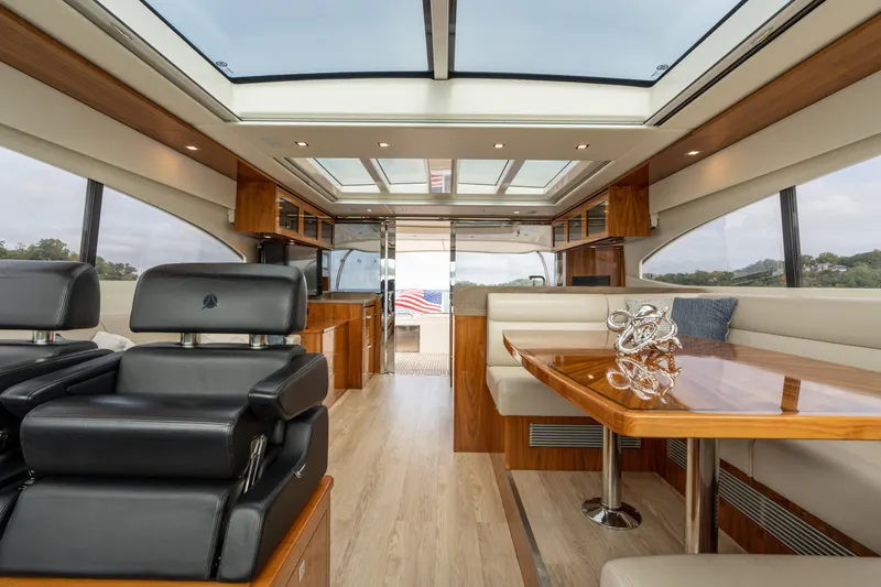 Slide: The Image of Luxurious interior of 2017 Riviera 6000 Sport Yacht with elegant seating and wooden finishes. - 27