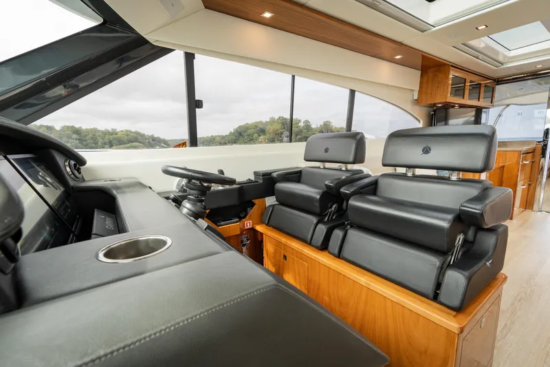 Slide: The Image of Luxurious interior of 2017 Riviera 6000 Sport Yacht with leather seating and modern helm. - 28