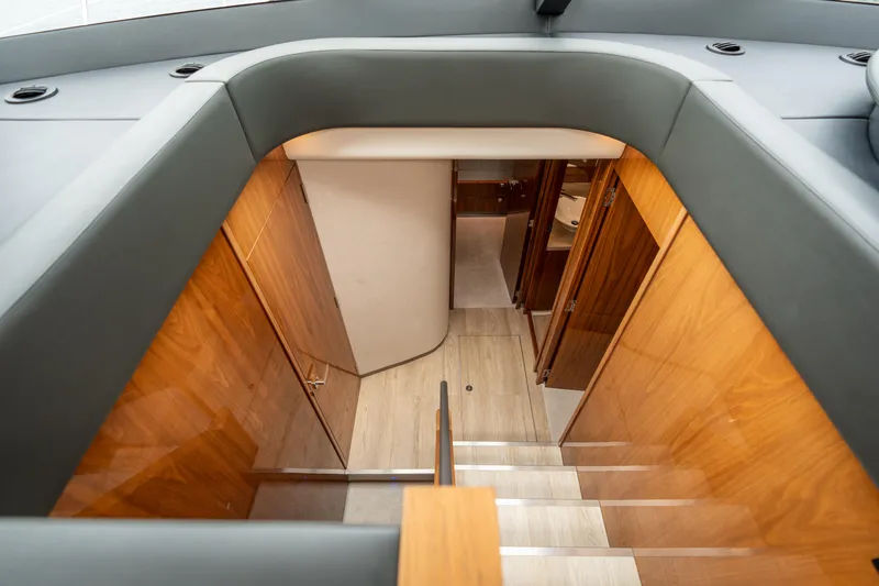 Slide: The Image of Interior staircase of 2017 Riviera 6000 Sport Yacht with wooden paneling and modern design. - 29