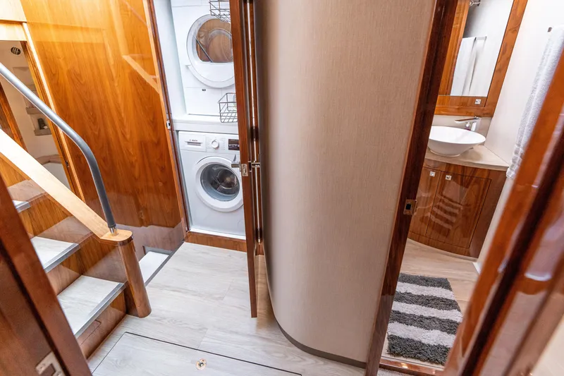 Slide: The Image of Interior of 2017 Riviera 6000 Sport Yacht with laundry area and bathroom. - 32