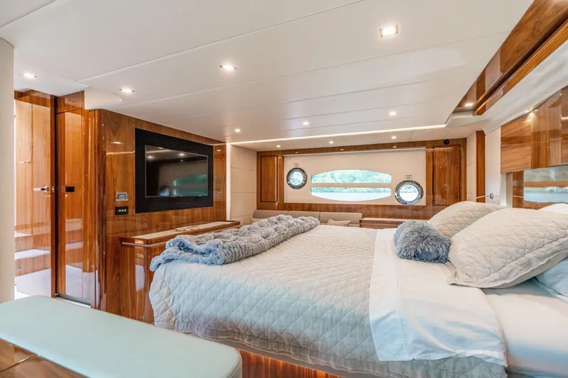 Slide: The Image of Luxurious bedroom interior of 2017 Riviera 6000 Sport Yacht with elegant wood finishes. - 38