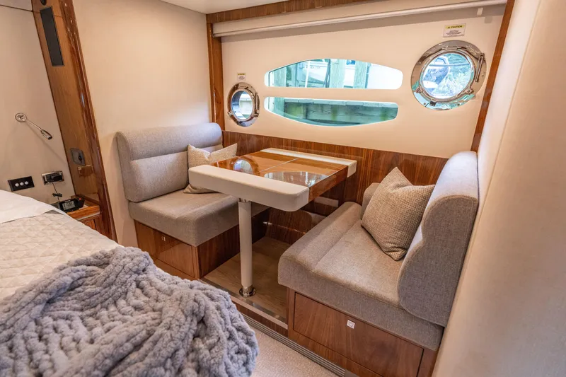 Slide: The Image of Luxurious interior of 2017 Riviera 6000 Sport Yacht with cozy seating and elegant decor. - 43