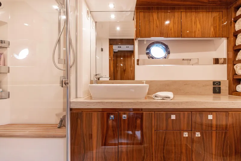 Slide: The Image of Luxurious bathroom in 2017 Riviera 6000 Sport Yacht with wood accents and modern fixtures. - 45
