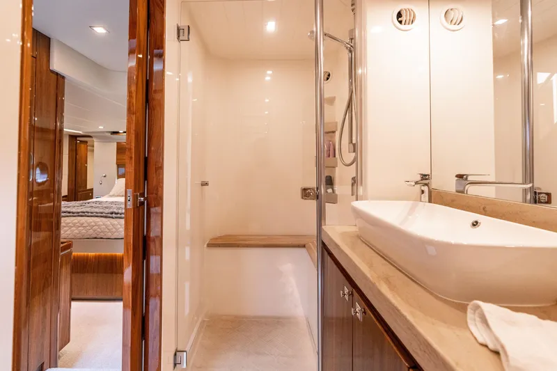 Slide: The Image of Luxurious bathroom interior of 2017 Riviera 6000 Sport Yacht with modern fixtures and elegant design. - 46