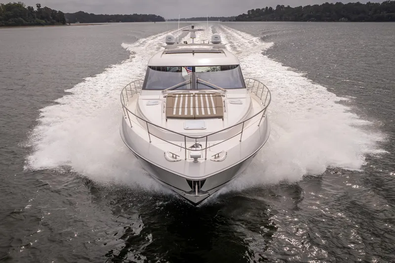 Slide: The Image of 2017 Riviera 6000 Sport Yacht cruising on a calm waterway. - 5