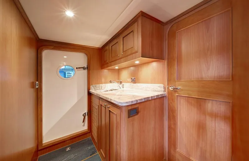 Slide: The Image of 2020 Outer Reef Yachts 720 Deluxbridge Motoryacht interior with wooden cabinetry and porthole. - 26