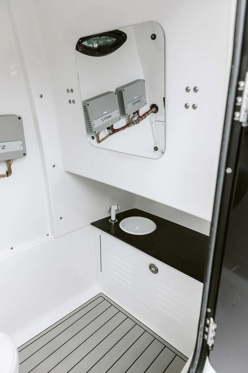 Slide: The Image of 2025 Sea Pro 292 DLX boat interior with modern sink and storage. - 10