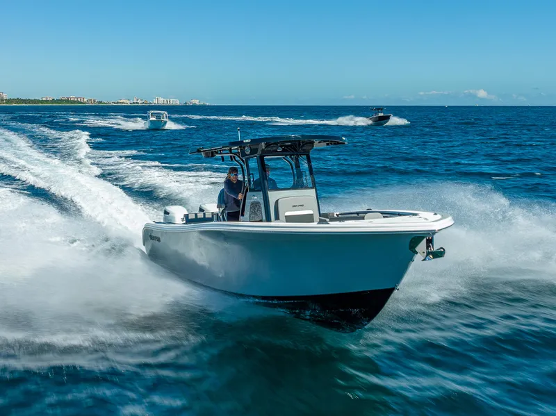 Slide: The Image of 2025 Sea Pro 292 DLX boat cruising on open water. - 11