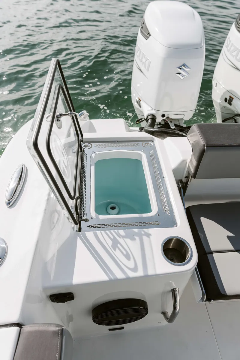 Slide: The Image of 2025 Sea Pro 292 DLX boat with dual Suzuki outboard motors on water. - 12