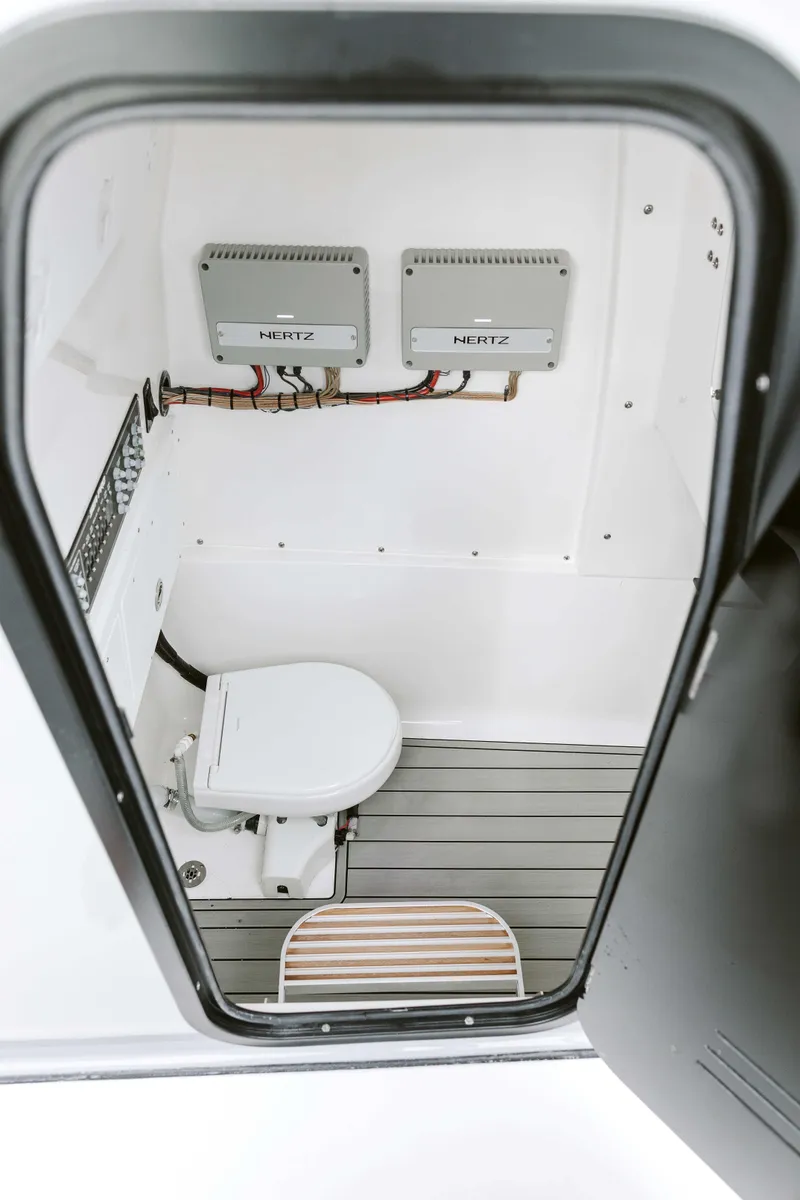 Slide: The Image of 2025 Sea Pro 292 DLX boat interior with toilet and electronic components. - 5
