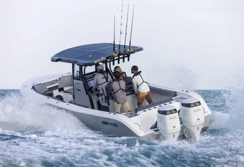 Slide: The Image of 2025 Sea Pro 292 DLX boat navigating through ocean waves with fishing rods. - 6