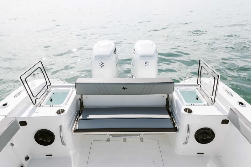 Slide: The Image of 2025 Sea Pro 292 DLX boat with dual engines and seating, on calm water. - 7