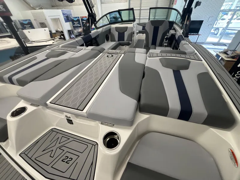 Slide: The Image of 2025 MasterCraft XT22 boat interior with sleek gray and blue seating design. - 10
