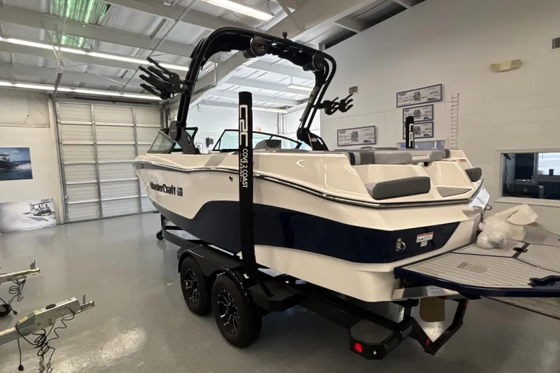 Slide: The Image of 2025 MasterCraft XT22 boat in showroom, featuring sleek design and modern amenities. - 11