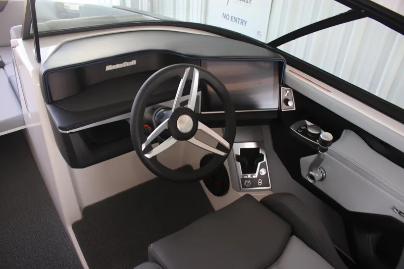 Slide: The Image of 2025 MasterCraft XT22 boat dashboard with modern steering wheel and controls. - 4