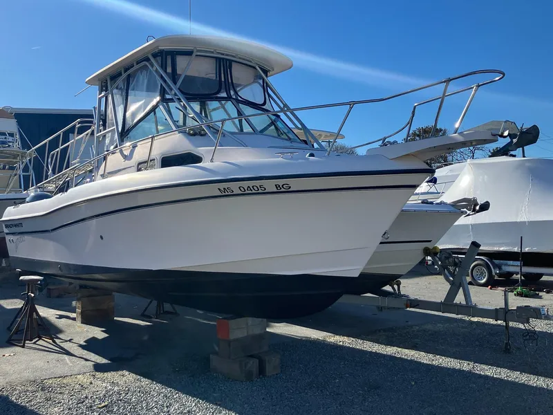 The Image of 2004 Grady-White 232 Gulfstream boat on blocks in a marina. - 0