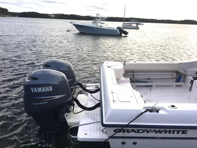 Slide: The Image of 2004 Grady-White 232 Gulfstream boat with Yamaha engines on water. - 11
