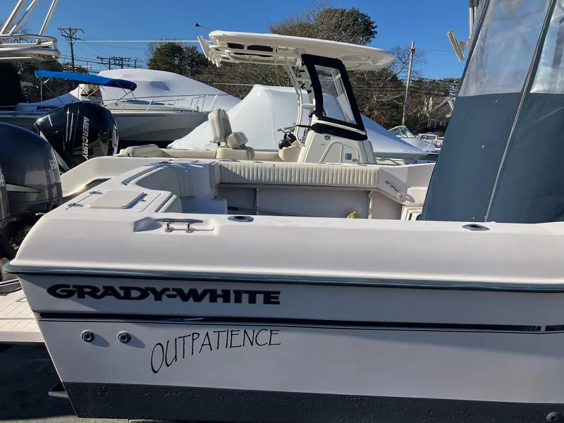 Slide: The Image of 2004 Grady-White 232 Gulfstream boat docked, featuring "Outpatience" name on the side. - 15