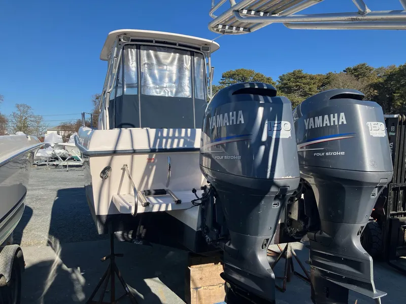 Slide: The Image of 2004 Grady-White 232 Gulfstream boat with twin Yamaha outboard engines. - 16