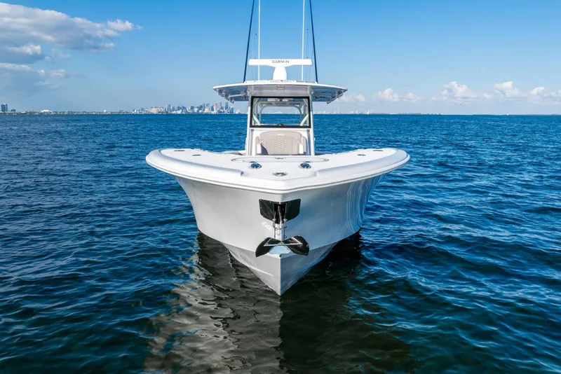 Slide: The Image of 2024 Yellowfin 39 boat on open water, clear sky, city skyline in background. - 11