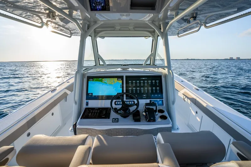 Slide: The Image of 2024 Yellowfin 39 boat cockpit with advanced navigation system on open water. - 12