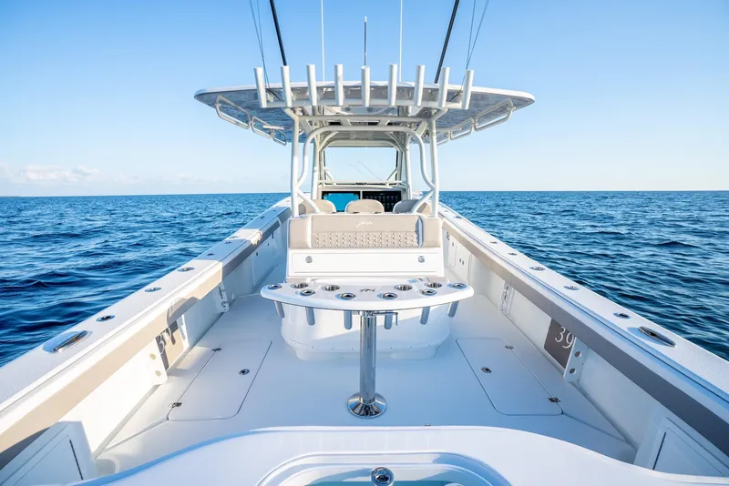 Slide: The Image of 2024 Yellowfin 39 boat on open ocean, showcasing spacious deck and fishing setup. - 18