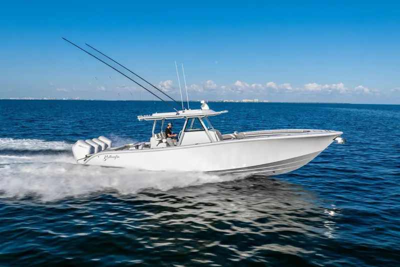 Slide: The Image of 2024 Yellowfin 39 boat cruising on open water under clear blue sky. - 3