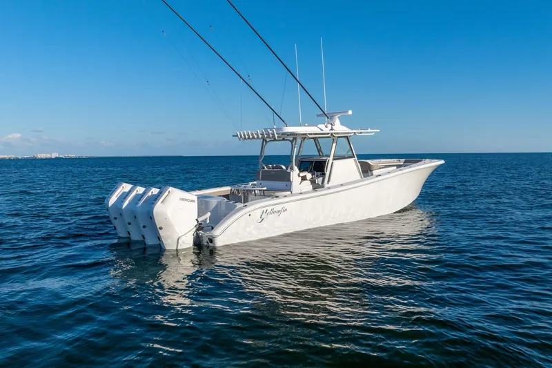 Slide: The Image of 2024 Yellowfin 39 boat on open water with clear blue sky. - 9