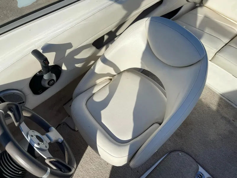Slide: The Image of 2007 Maxum 1900 SR-3 boat interior with steering wheel and white seating. - 12