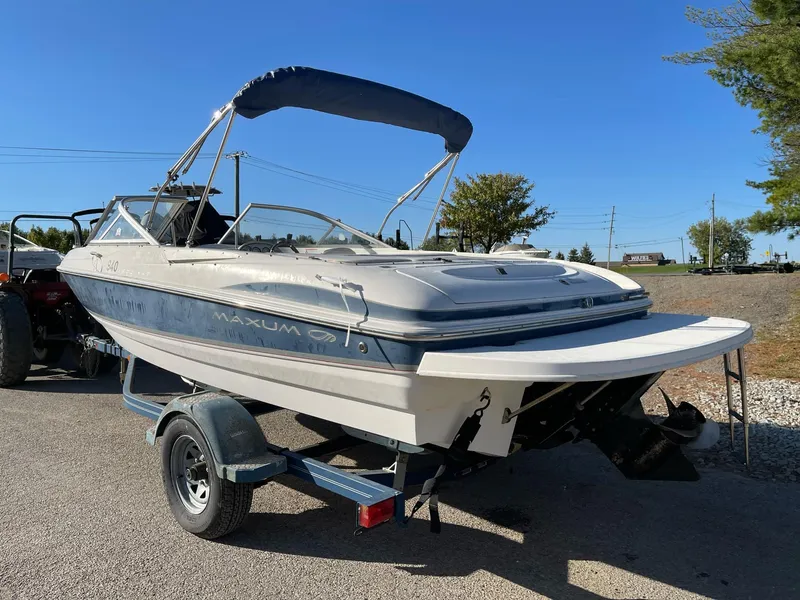 Slide: The Image of 2007 Maxum 1900 SR-3 boat on trailer, blue canopy, parked outdoors. - 3