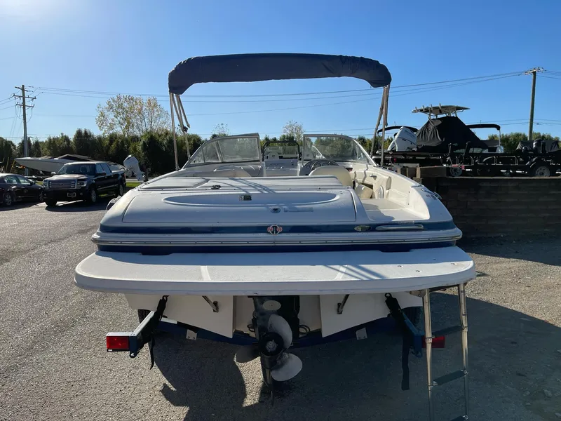 Slide: The Image of 2007 Maxum 1900 SR-3 boat with canopy, parked outdoors on a sunny day. - 4