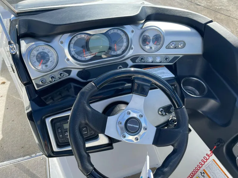 Slide: The Image of 2010 Sea-Doo 210 Challenger dashboard with steering wheel and gauges. - 10