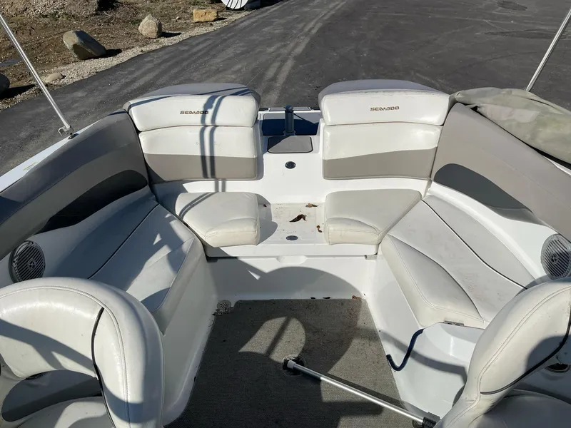 Slide: The Image of 2010 Sea-Doo 210 Challenger boat interior with white seating and gray accents. - 15