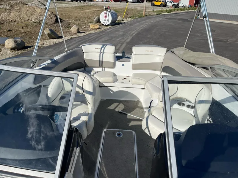 Slide: The Image of 2010 Sea-Doo 210 Challenger boat interior with white seating and windshield. - 16