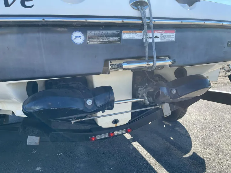 Slide: The Image of 2010 Sea-Doo 210 Challenger boat rear view, showing dual exhaust and trailer attachment. - 18