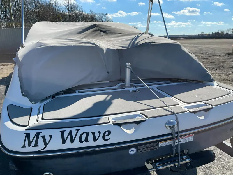 Slide: The Image of 2010 Sea-Doo 210 Challenger boat, covered, with "My Wave" name, parked outdoors. - 3