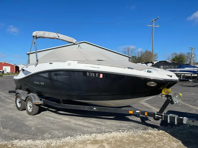 Slide: The Image of 2010 Sea-Doo 210 Challenger boat on trailer, parked outdoors. - 5