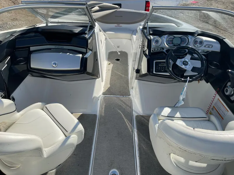 Slide: The Image of 2010 Sea-Doo 210 Challenger boat interior with dual seating and dashboard. - 7